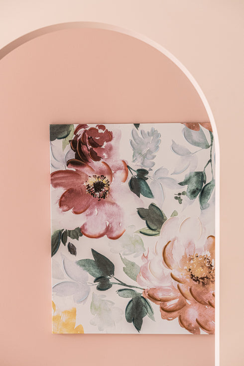 A Print Art in White and multiple colors, on a pink wall